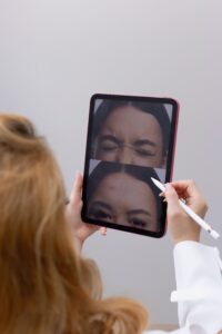 A doctor showing botox Relaxer Cost in Melbourne- Units, Doses and What to Expect to Pay to a patient